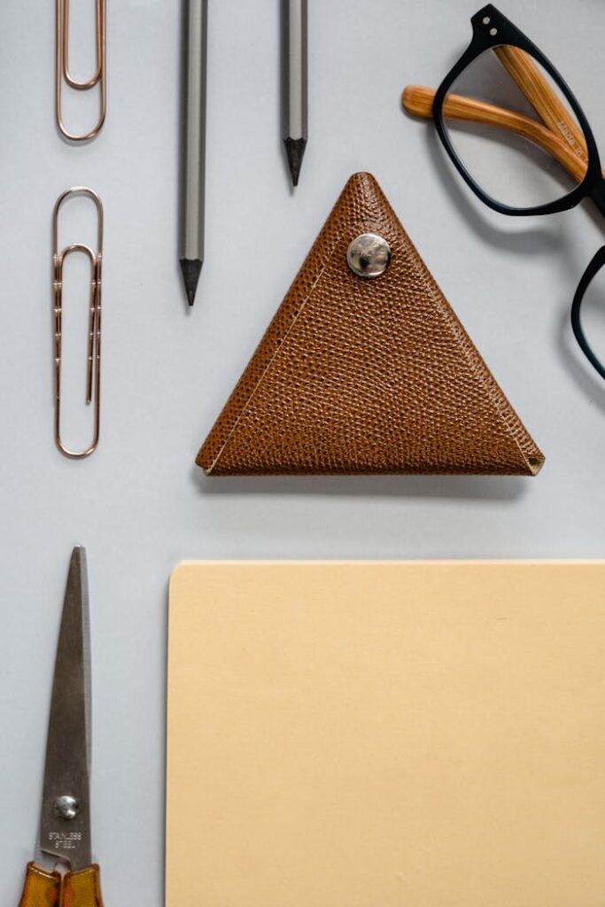 Bookkeeping Wisdom: An Unexpected Conversation in an Uber Ride A top view flat lay of office essentials including a triangular case and glasses.